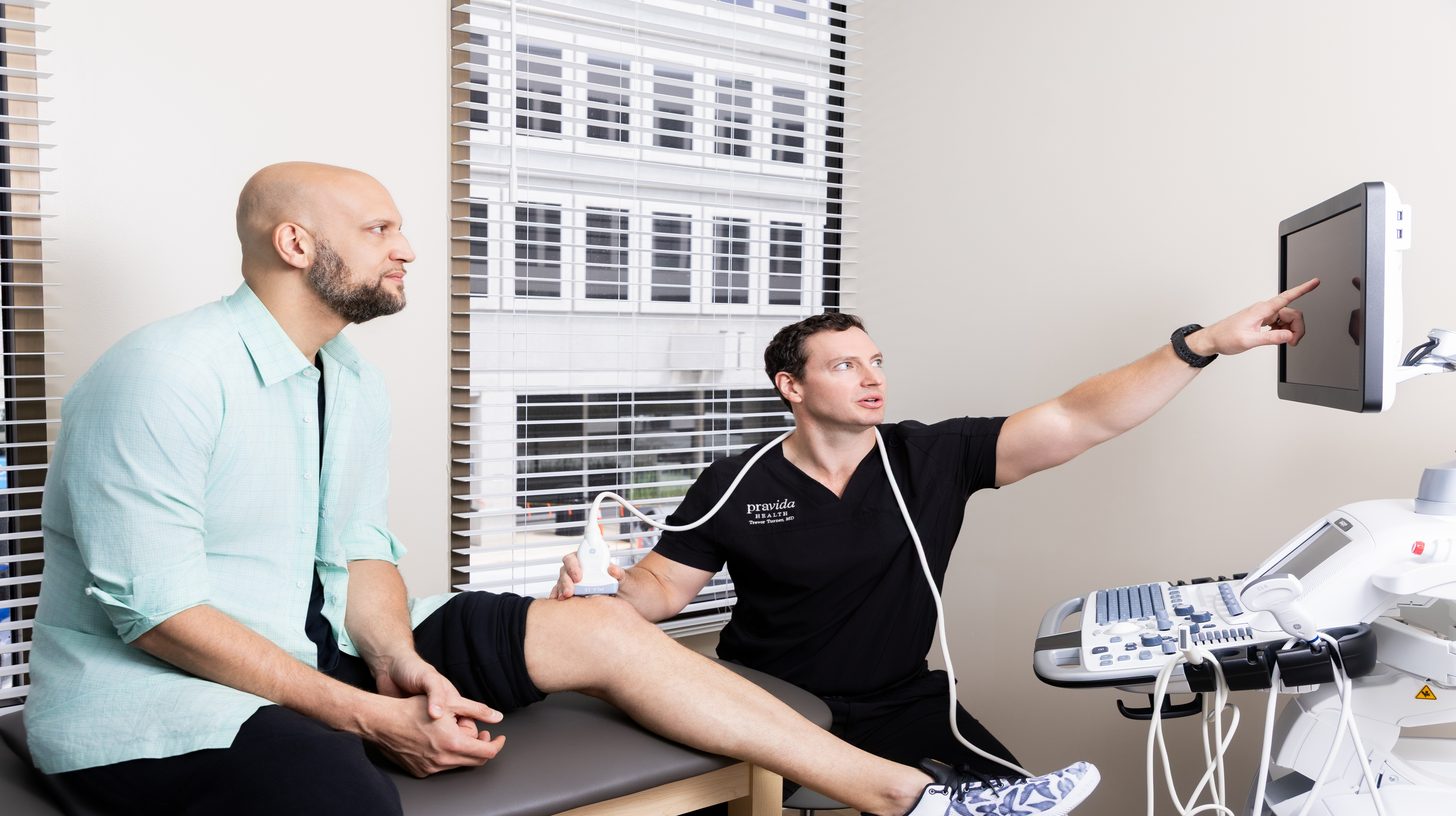 Dr. Turner performing knee ultrasound examination on patient at Pravida Health